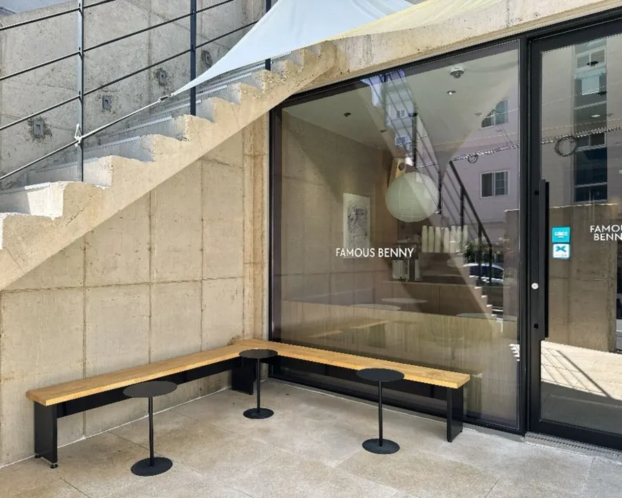 The café's exterior wall with a bare, unpainted cement finish