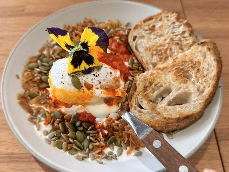 Close-up of the garlic butter egg with the poached egg broken open