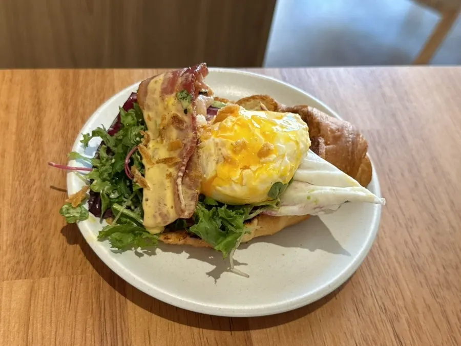 Close-up of The Famous Benny topped with sabayon sauce