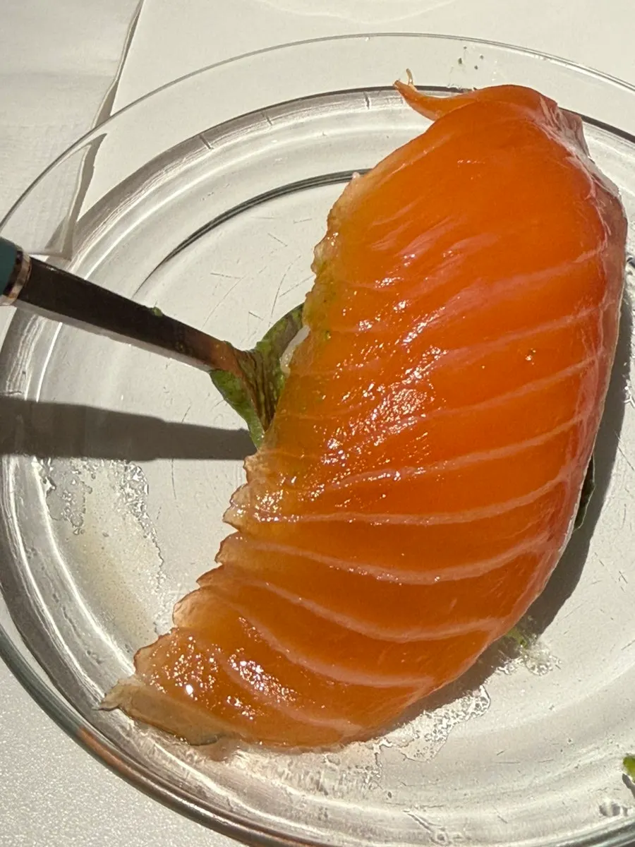 Taking a big bite of thick salmon sushi