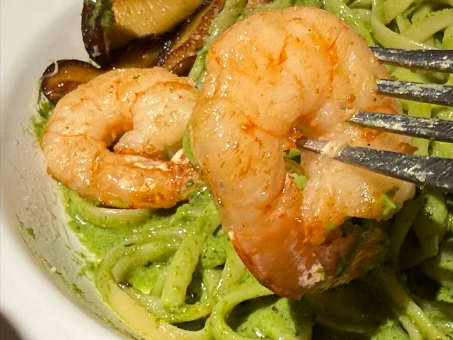 Plate of basil pesto pasta with grilled shrimp