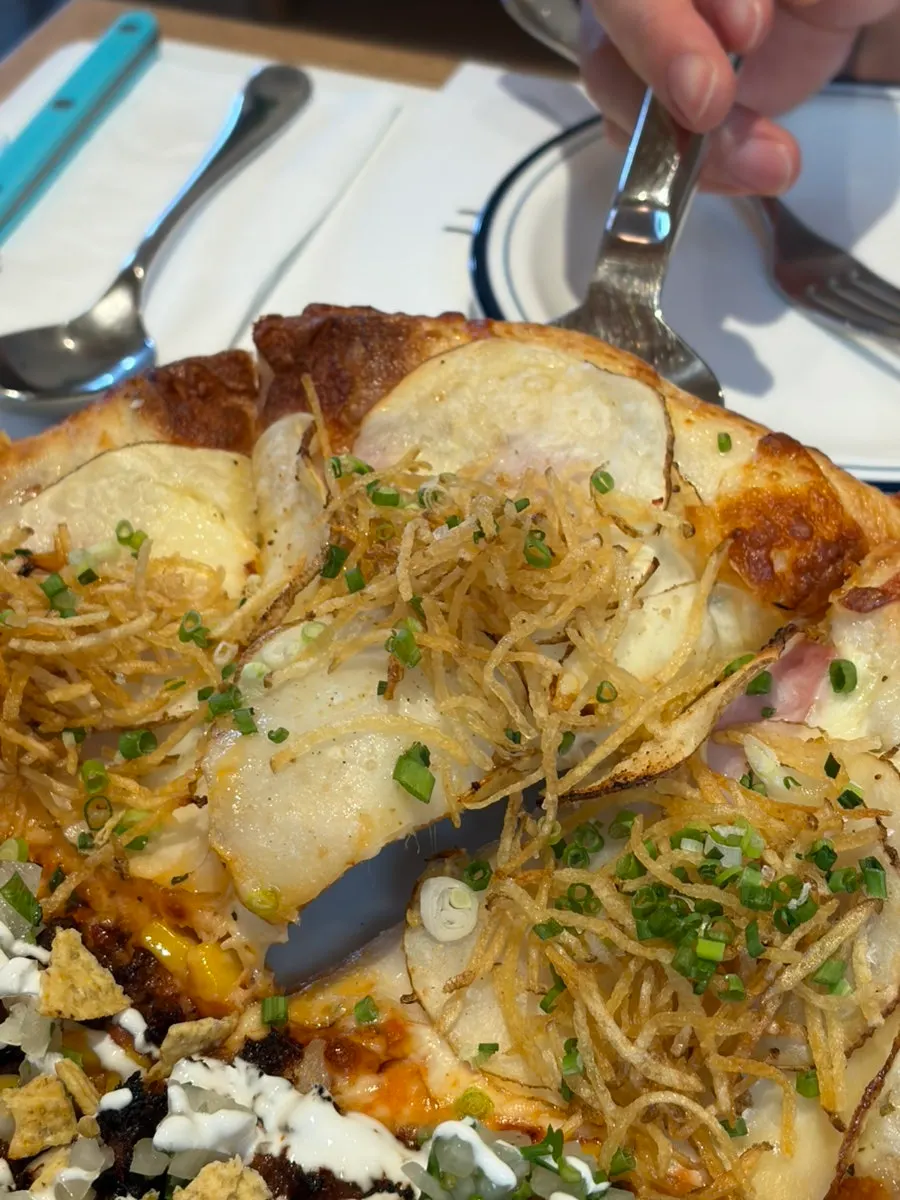 Potato pizza topped with fried potato shreds