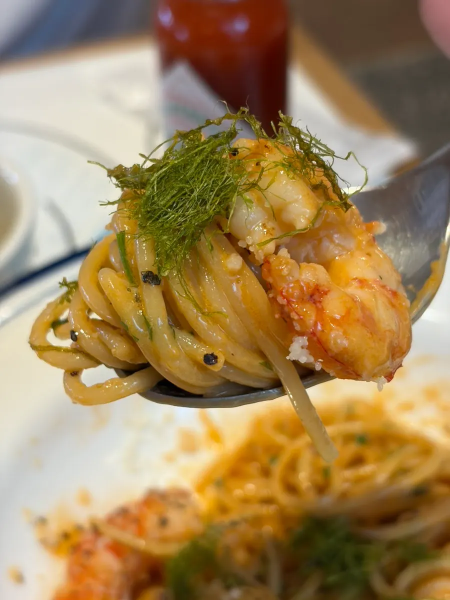 Pasta noodles coated in sauce with shrimp