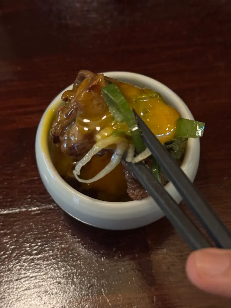 A piece of sirloin dipped in egg yolk seasoning sauce