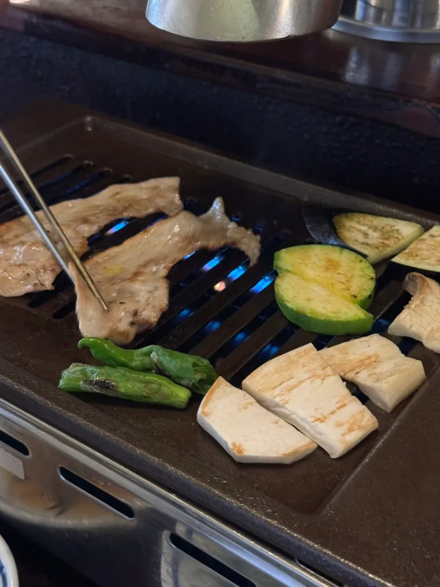 Thin pork belly slices placed on the grill