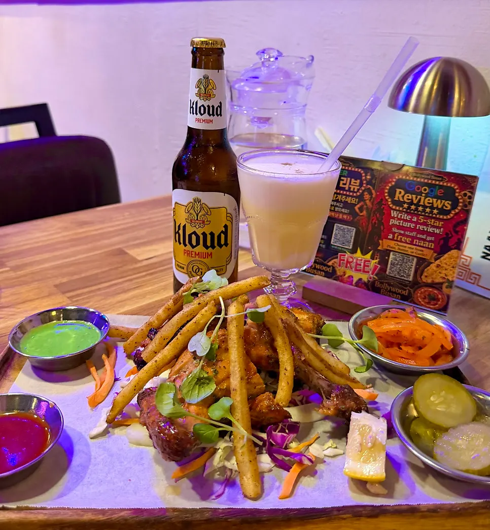Table setting with mango lassi and Indian food