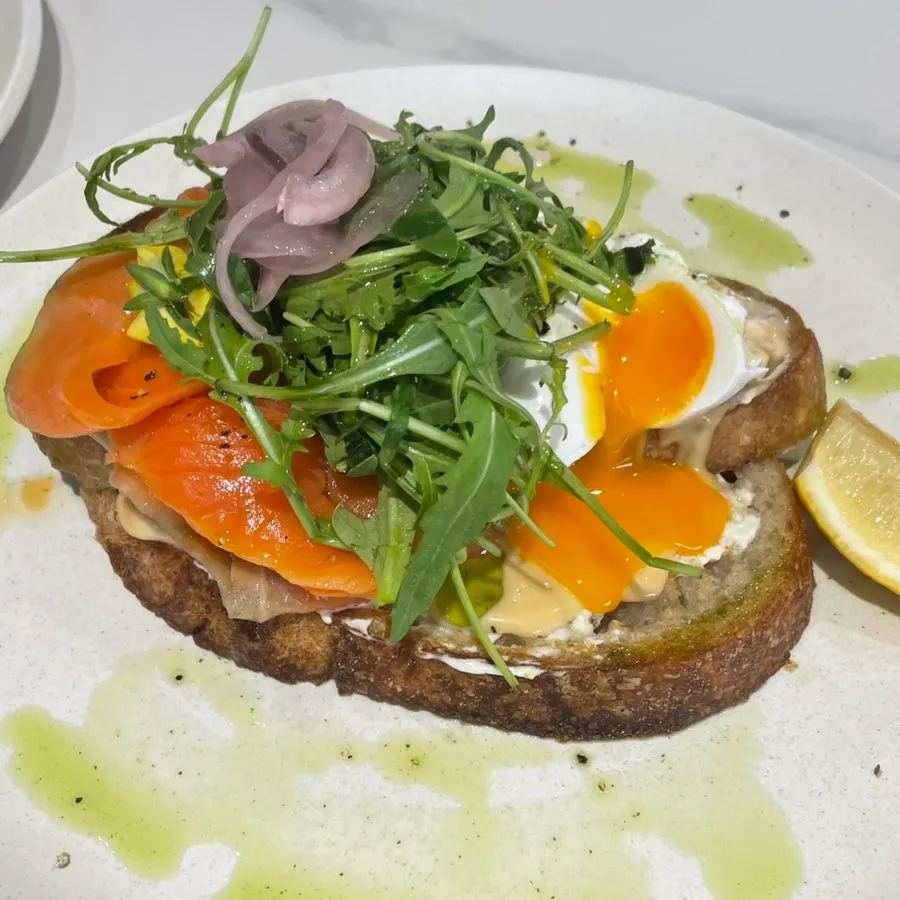 Close-up of smoked salmon toast topped with soft-boiled egg