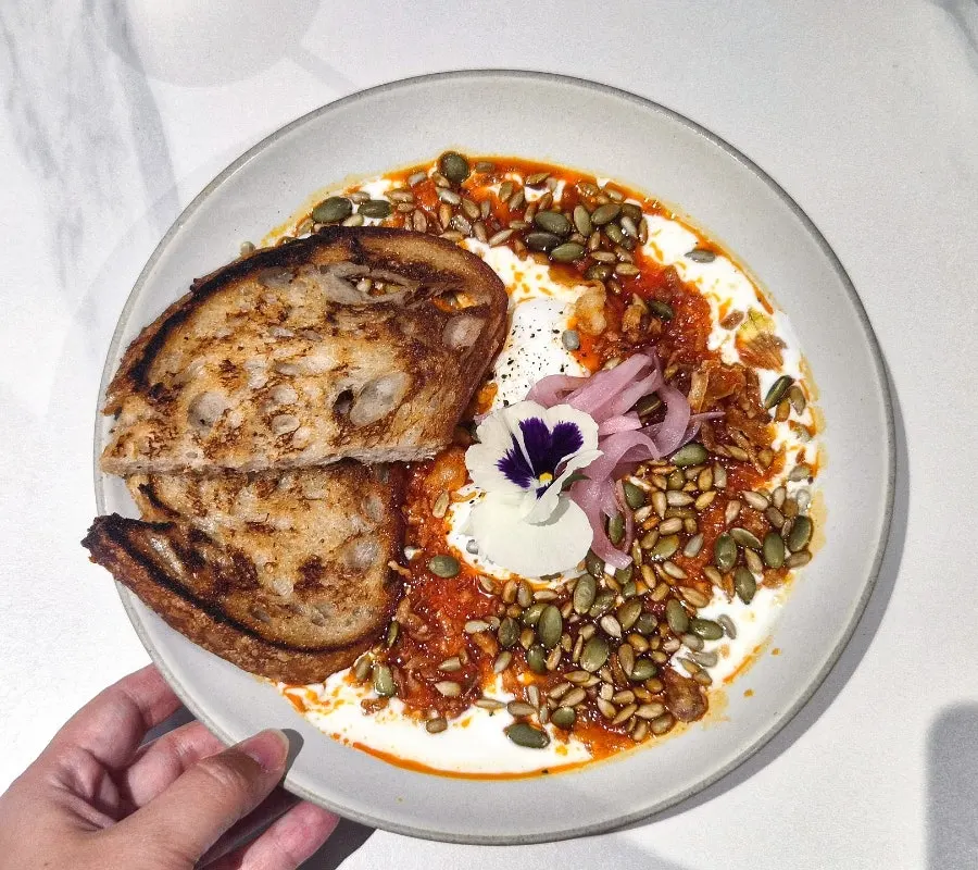 A plate of garlic butter egg, a Turkish-style poached egg dish