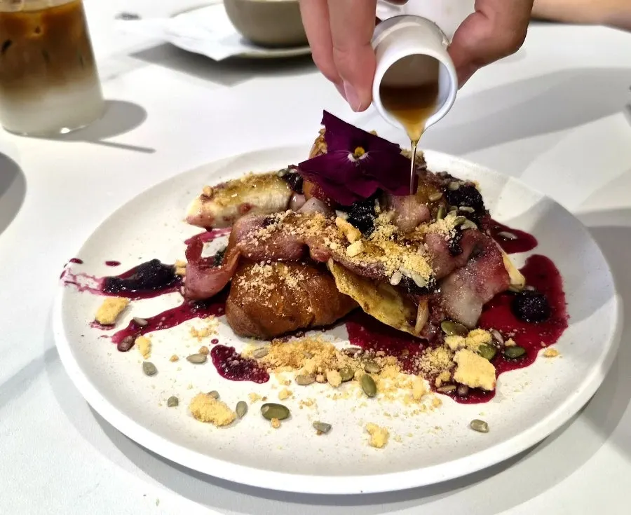 Famous Benny's French toast topped with edible flowers