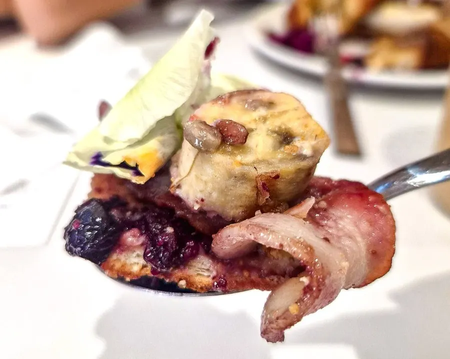 French toast served with croissant, bacon, and berry compote