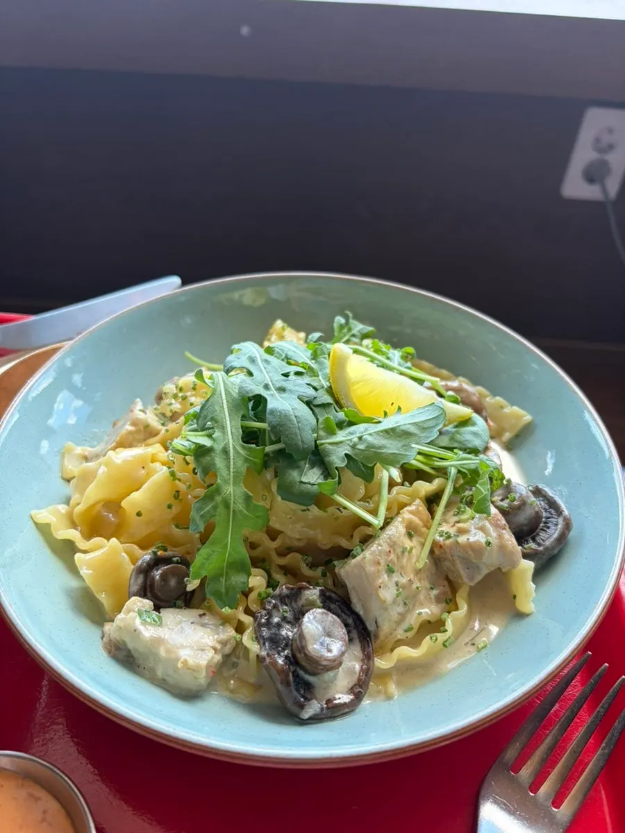 A plate of chicken cream pasta with mafaldine noodles