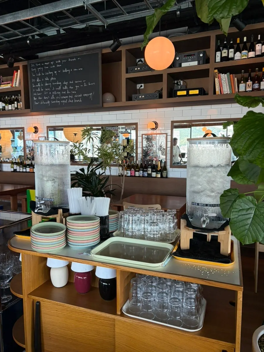 Self-serve bar with water, plates, and straws