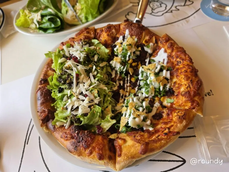 Half birria taco and half salad pizza