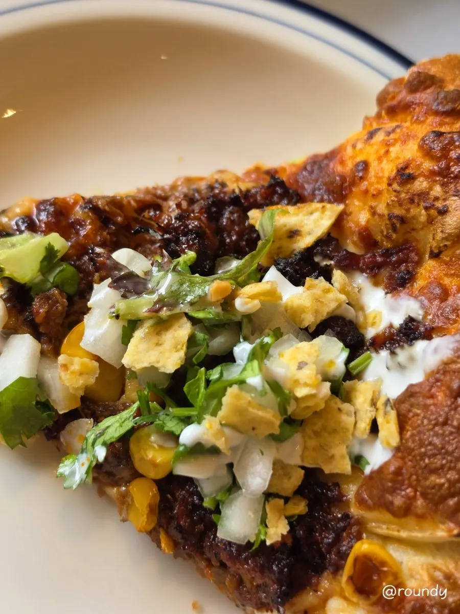 Birria taco pizza with nacho topping