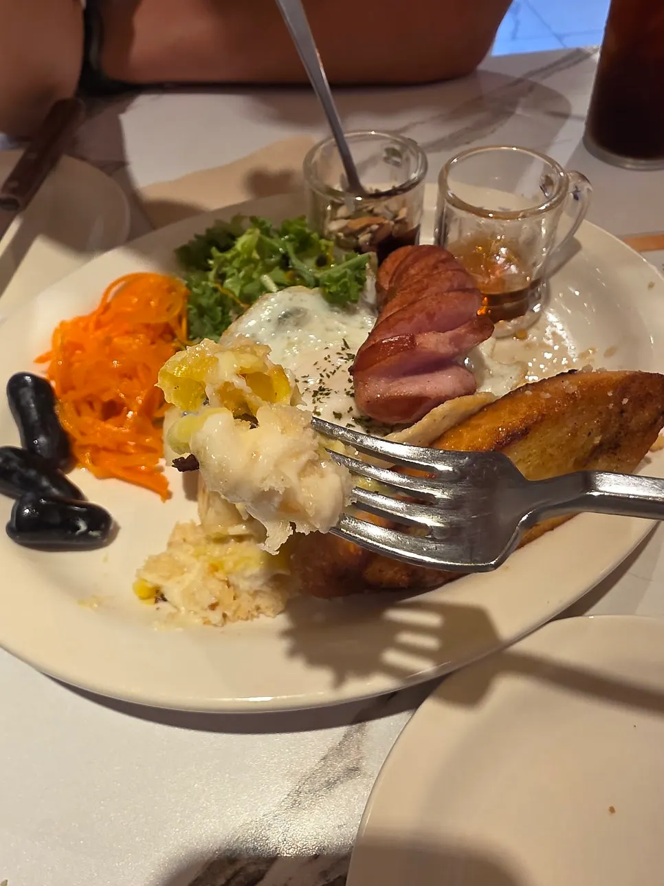 A soft piece of French toast cut with a fork
