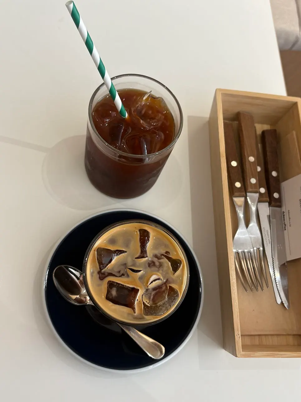 Long black and iced Americano on the table