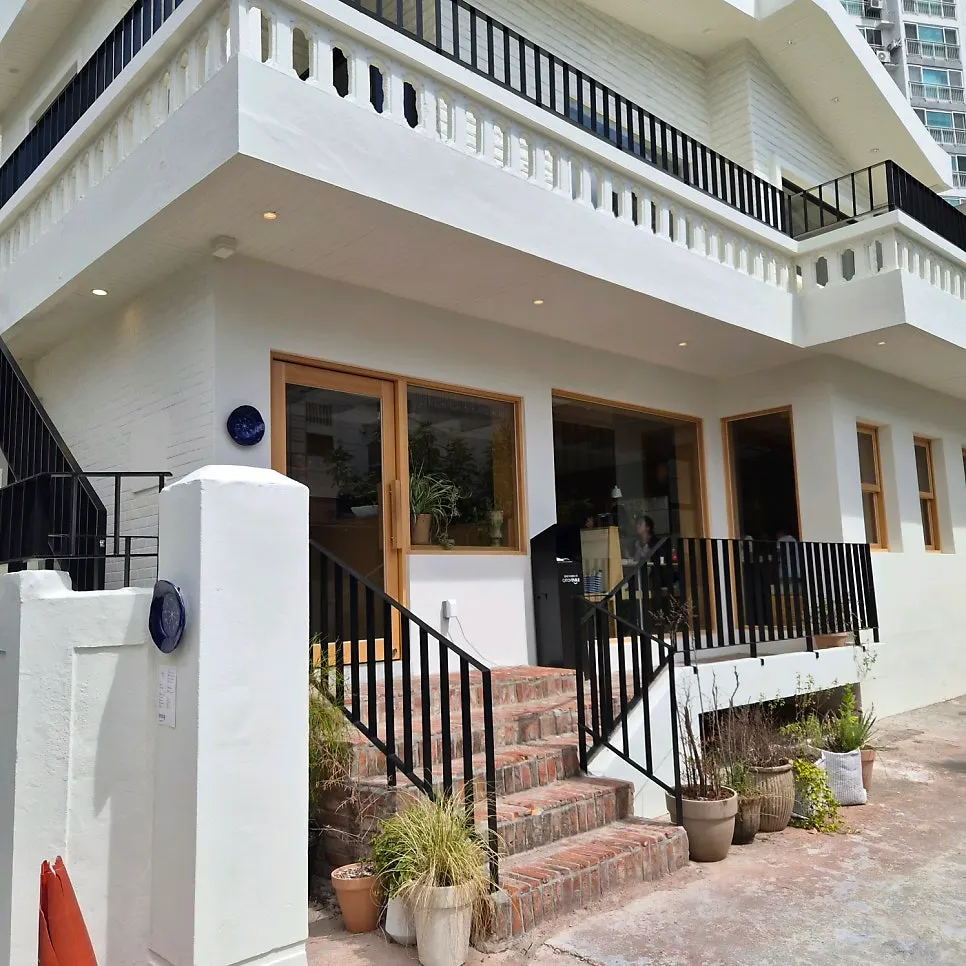 Exterior of Extra Mile, which looks like a converted house