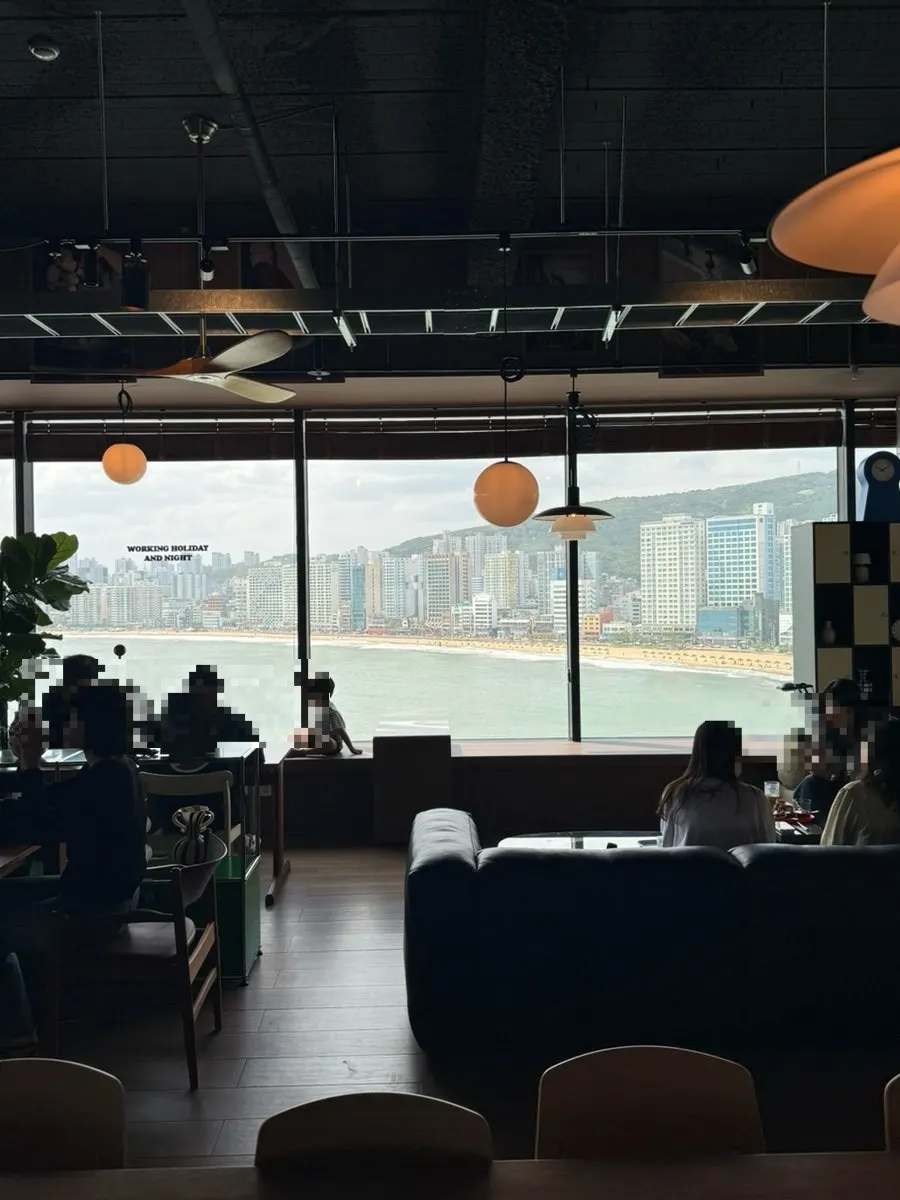 Open ocean-view seating by floor-to-ceiling windows