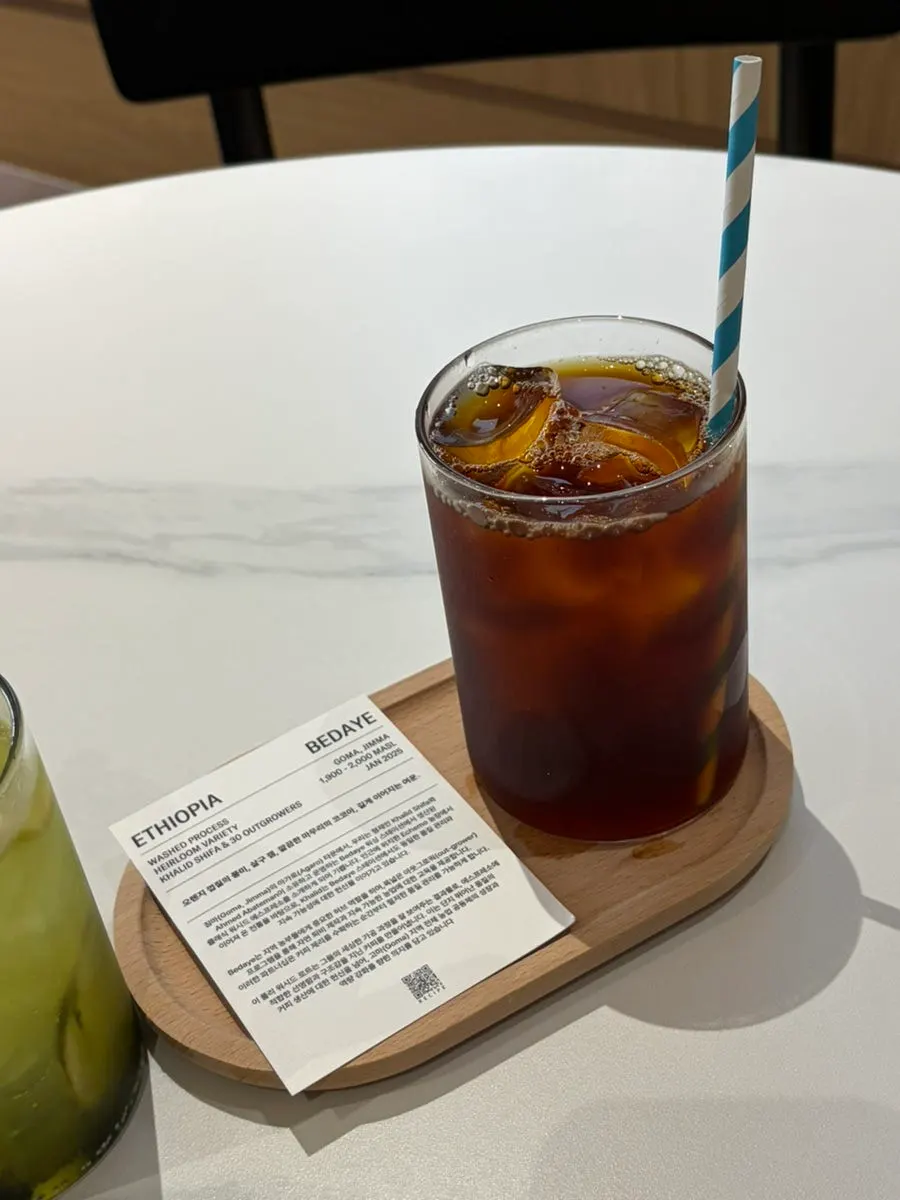 Iced drip coffee served with a bean info card