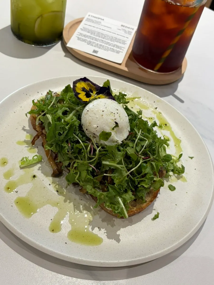 Two plates of toast topped with edible flowers