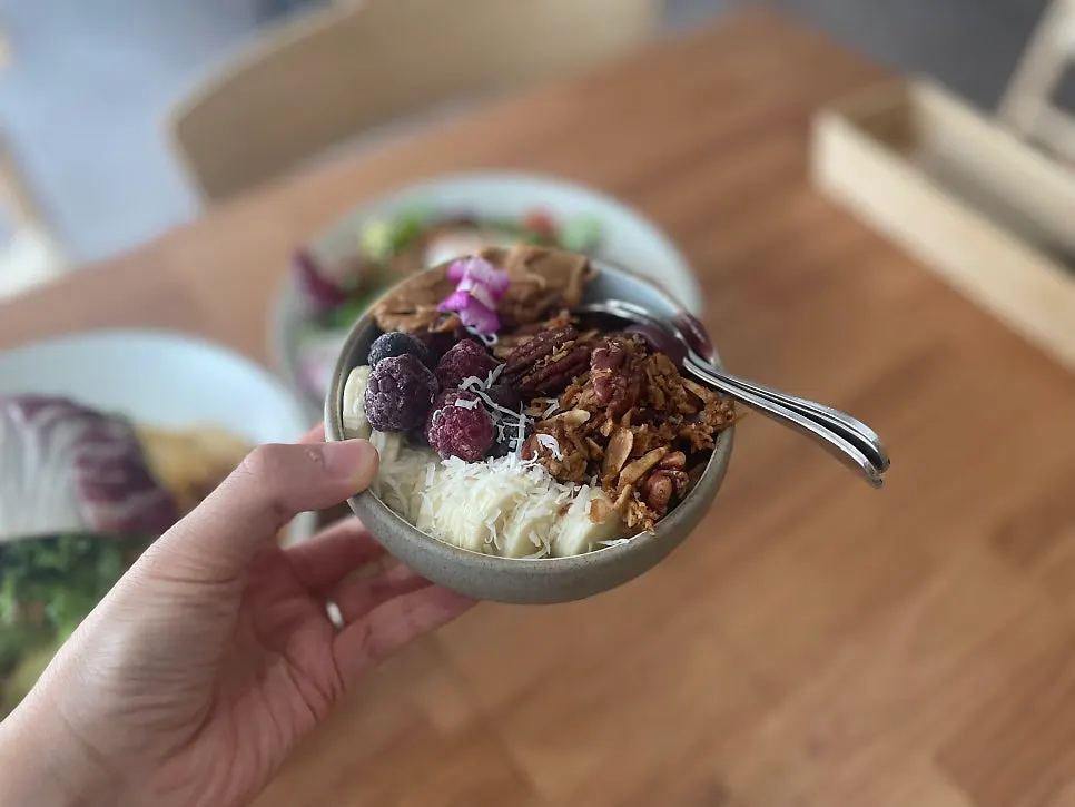 An acai bowl topped with blueberries and banana granola