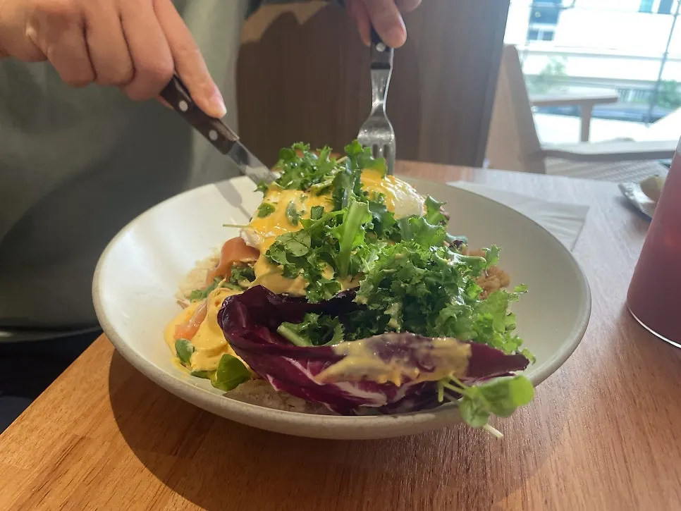 A plate combining salmon, egg, vegetables, and bread