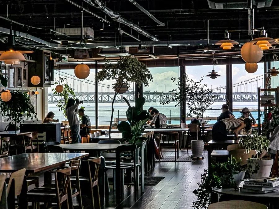 Seating with wide-open Gwangalli ocean view through floor-to-ceiling windows