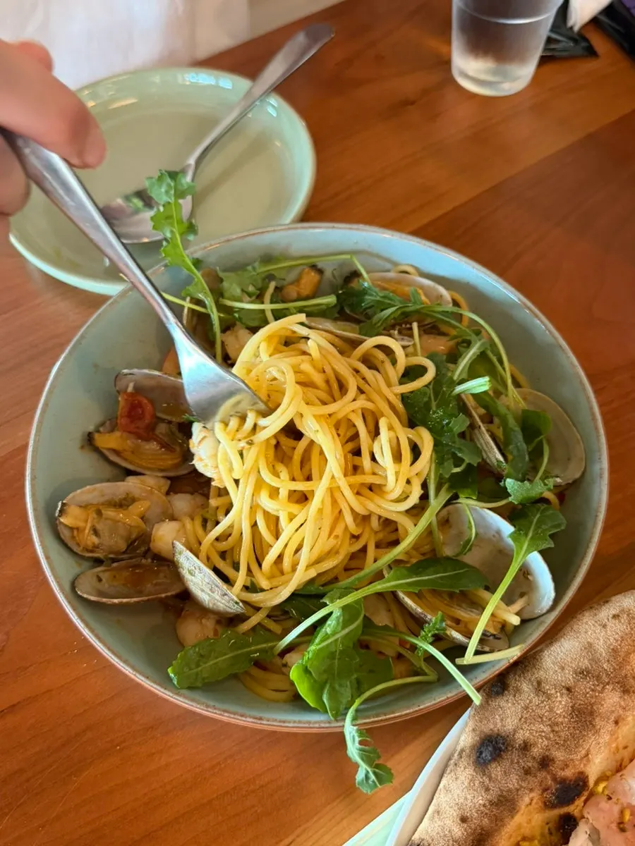 Close-up of oil pasta topped with whole shrimp