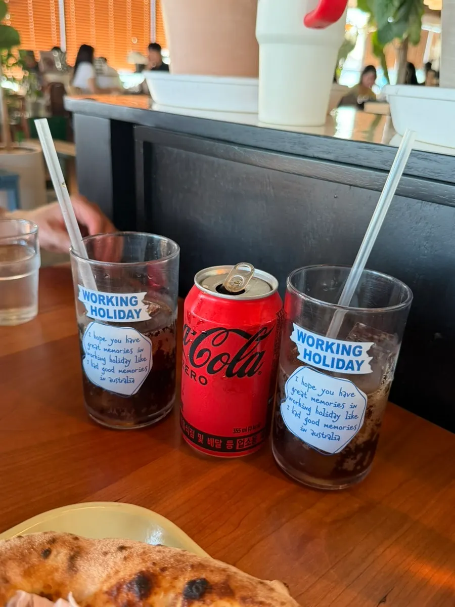 A table with cola and a glass of ice