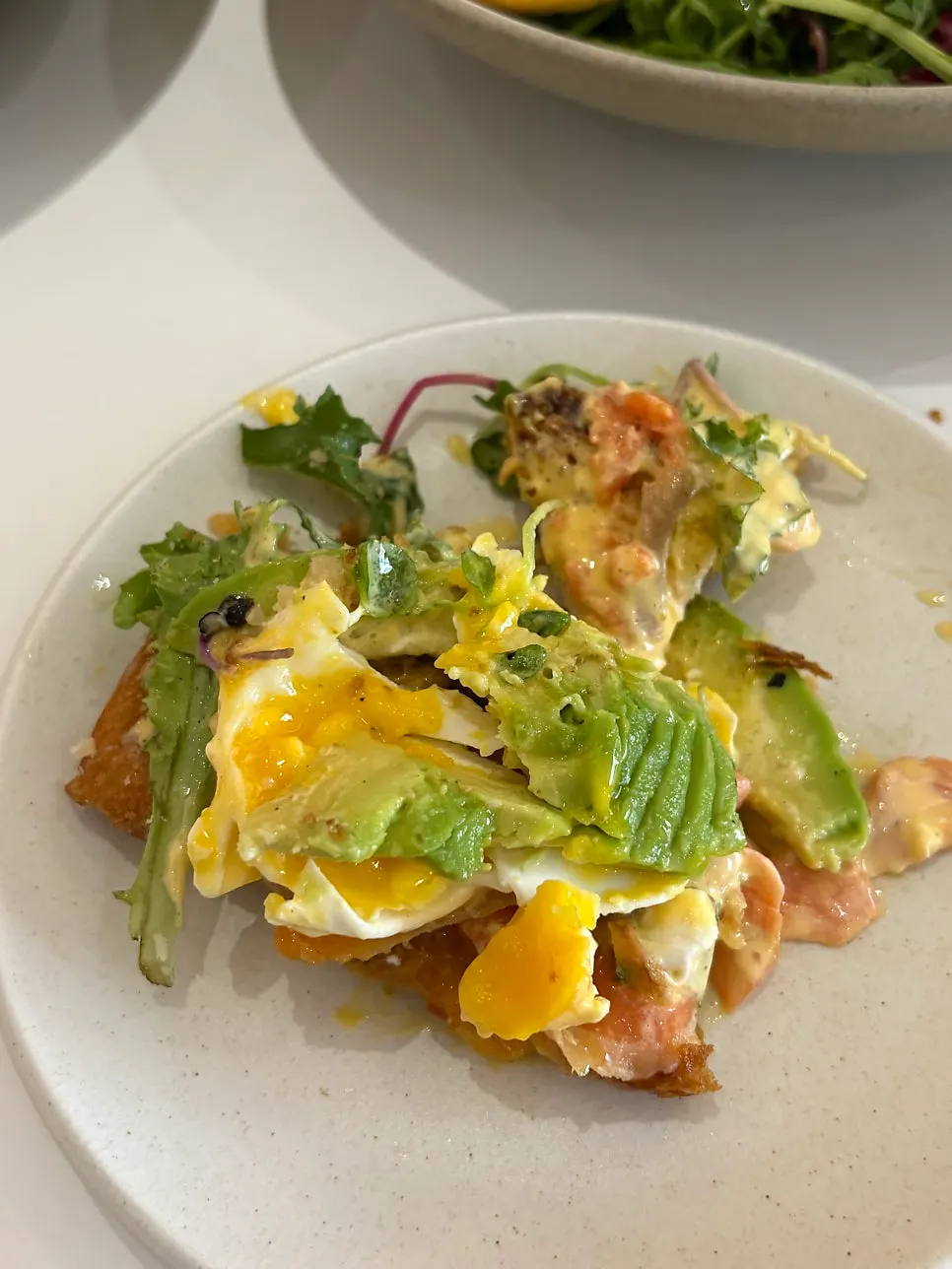 Poached egg, salmon, and avocado revealed after clearing the vegetables