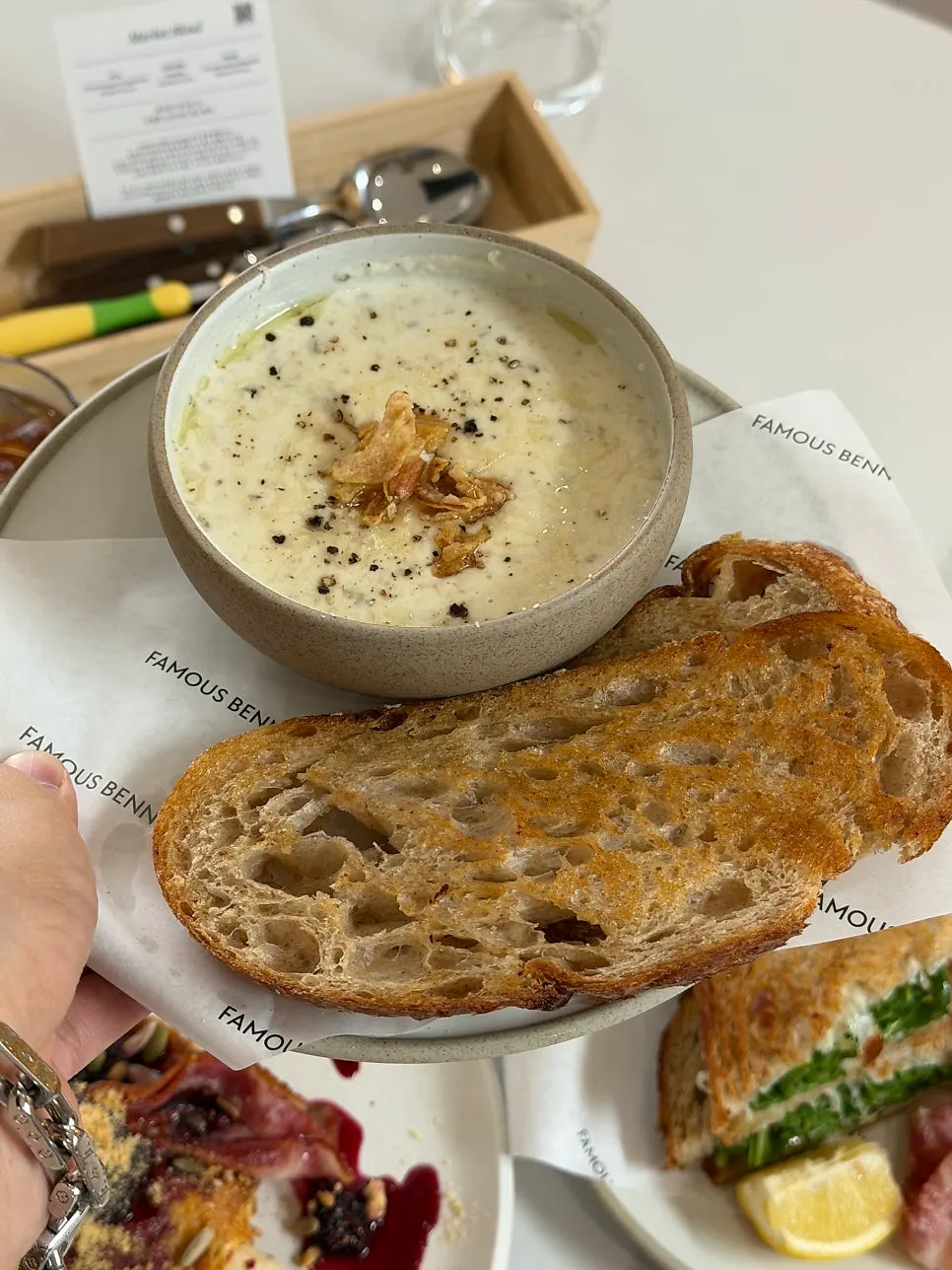 Dipping sourdough bread into the mushroom soup