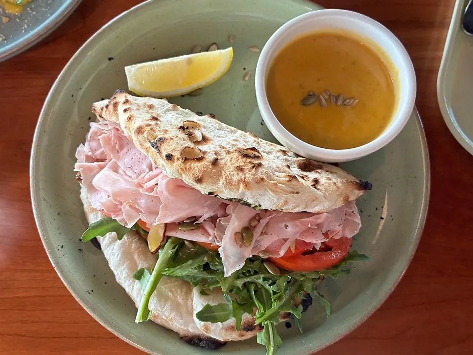 Wood-fired tortilla panuozzo topped with jambon and arugula