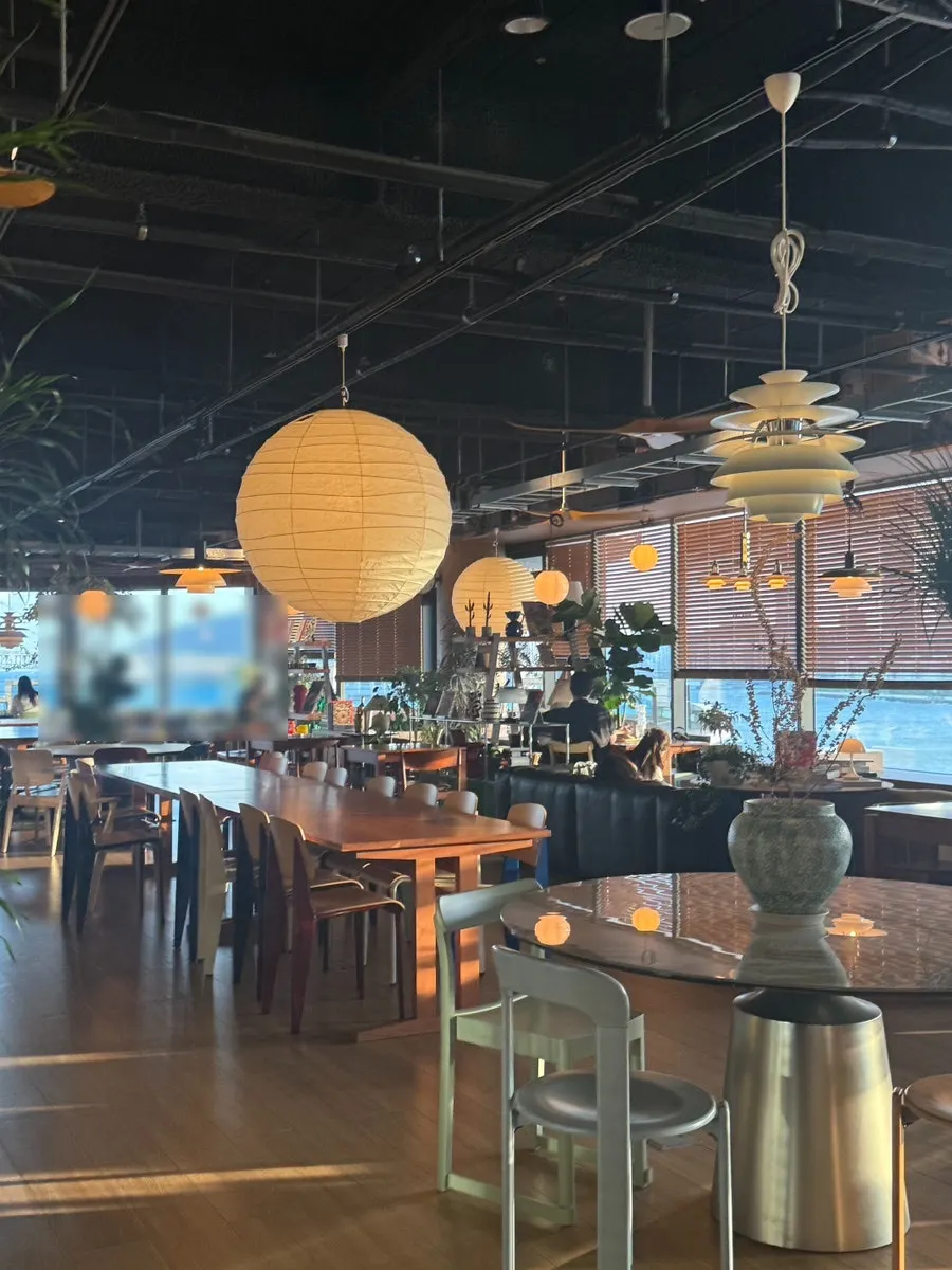 Seating with Gwangan Bridge ocean view through floor-to-ceiling windows