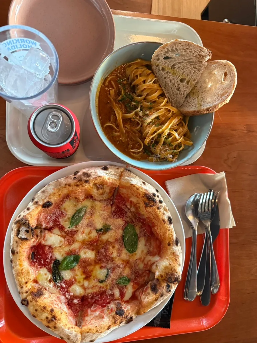 Margherita pizza and Bolognese pasta on the table