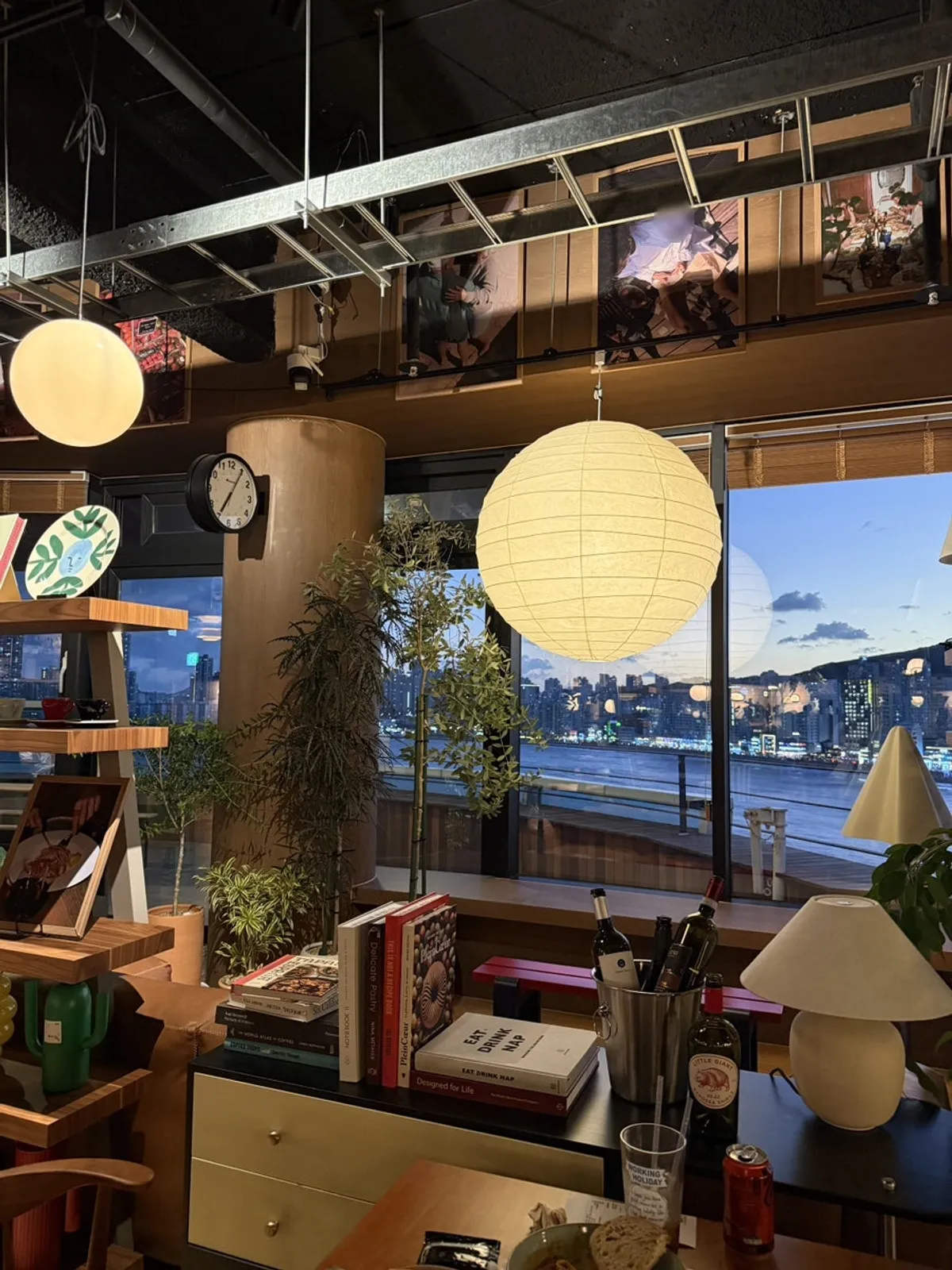 View of Gwangan Bridge and the moon at sunset through the window
