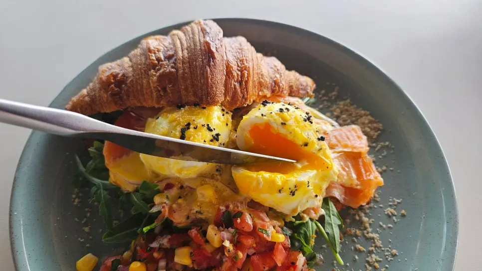 Brunch dishes plated with the Gwangalli view in the background