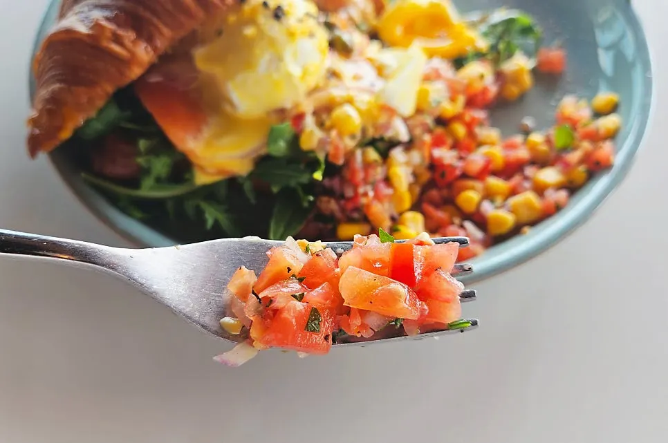 Croissant Benedict topped with smoked salmon and poached egg