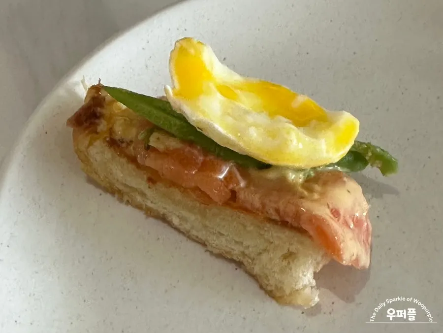 Croissant with a popped poached egg, salmon and avocado