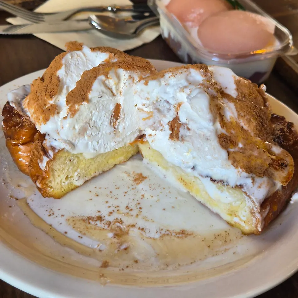 Cross-section of French toast topped with cream