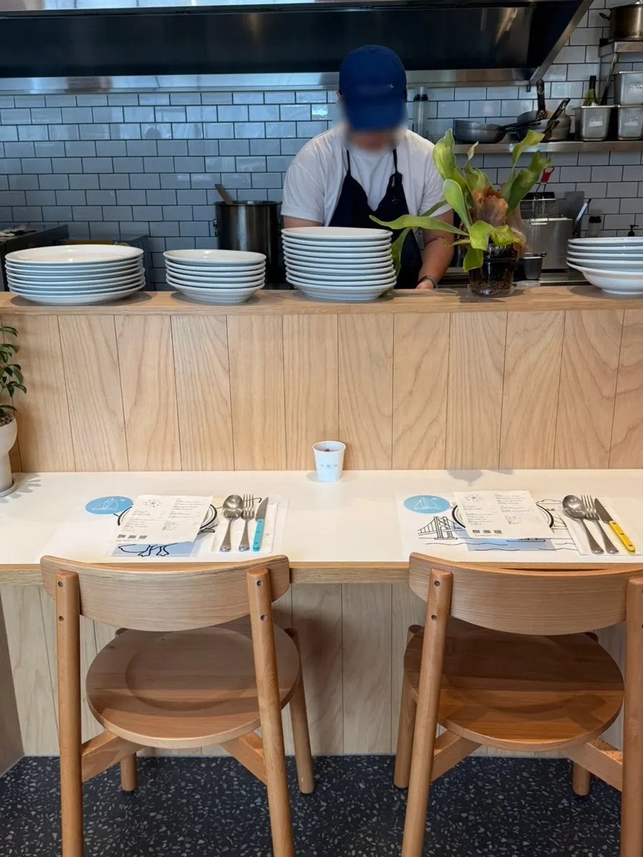 Dining hall at Extra Mile with view of the open kitchen