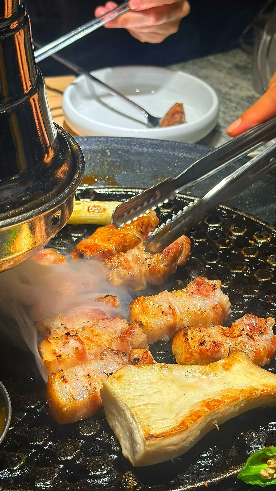 Thick pork belly sizzling on the grill