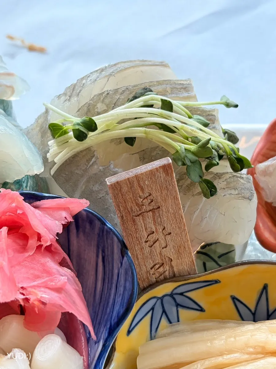 Picking up a piece of assorted sashimi