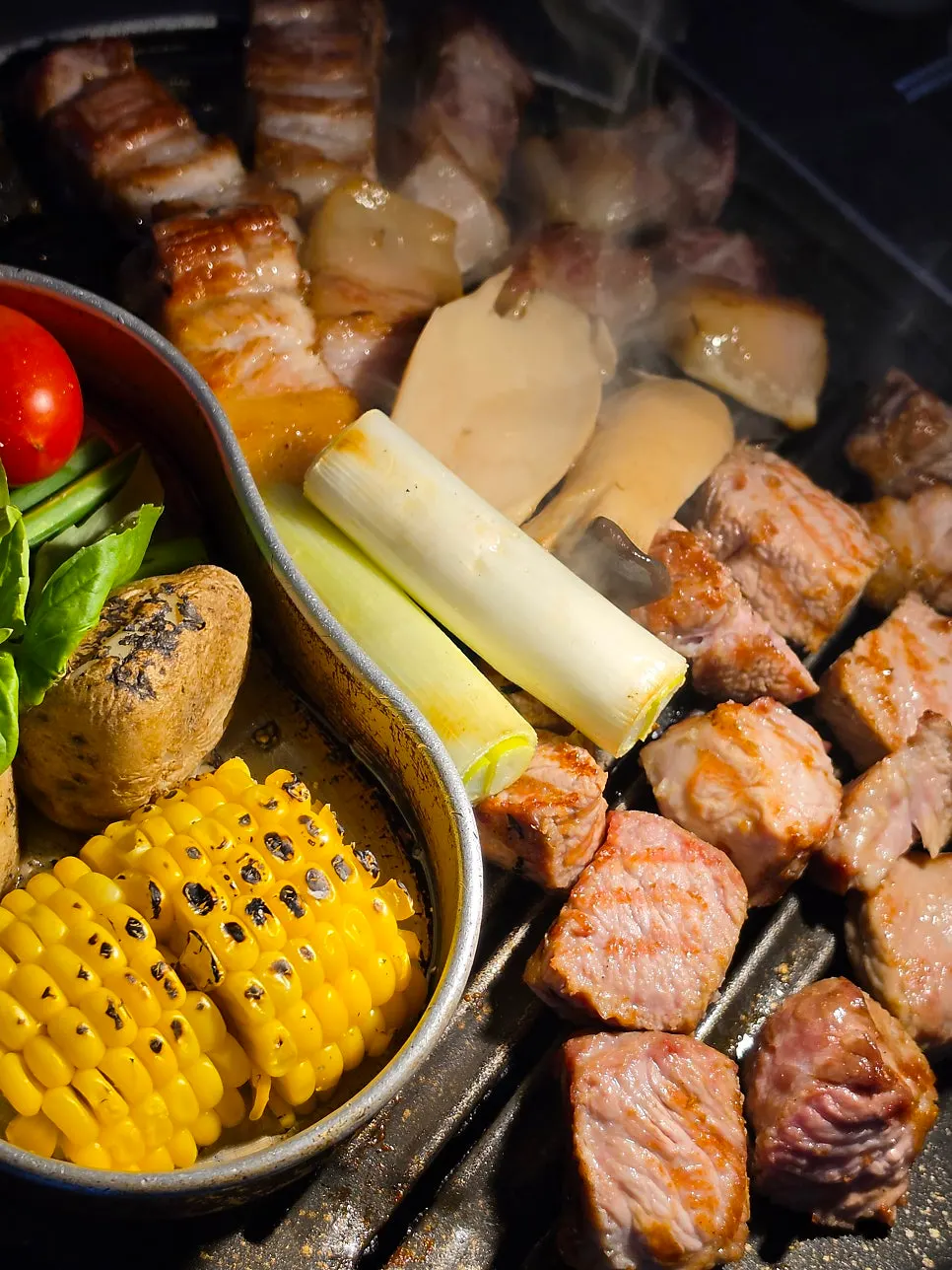 Meat being finished on the grill at the table