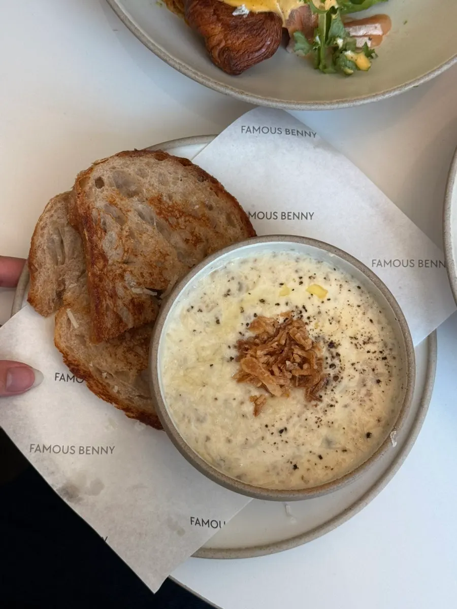 Creamy mushroom soup served with two pieces of bread