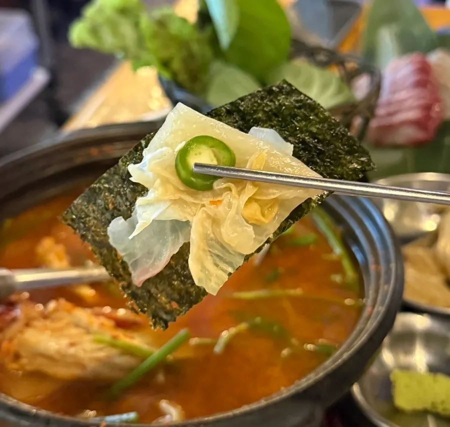Piece of live fish sashimi dipped in chojang