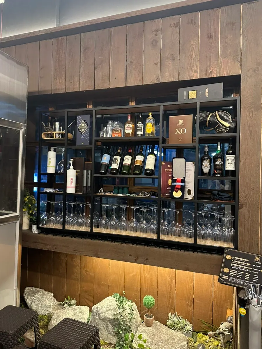 Liquor display case and pre-searing area on one side of the restaurant
