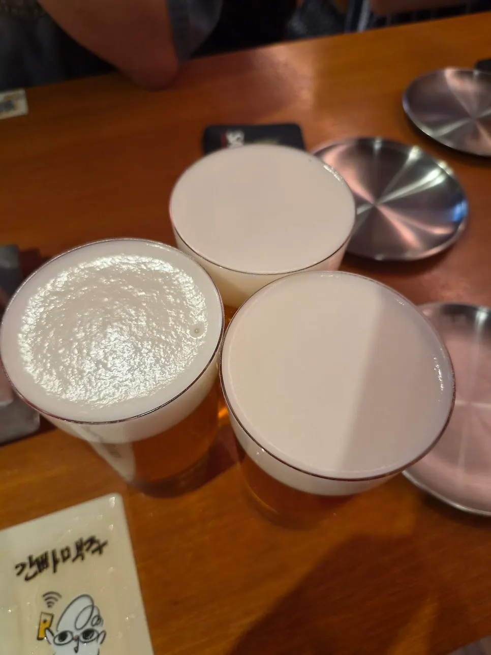 A glass of draft beer with a generous foam head
