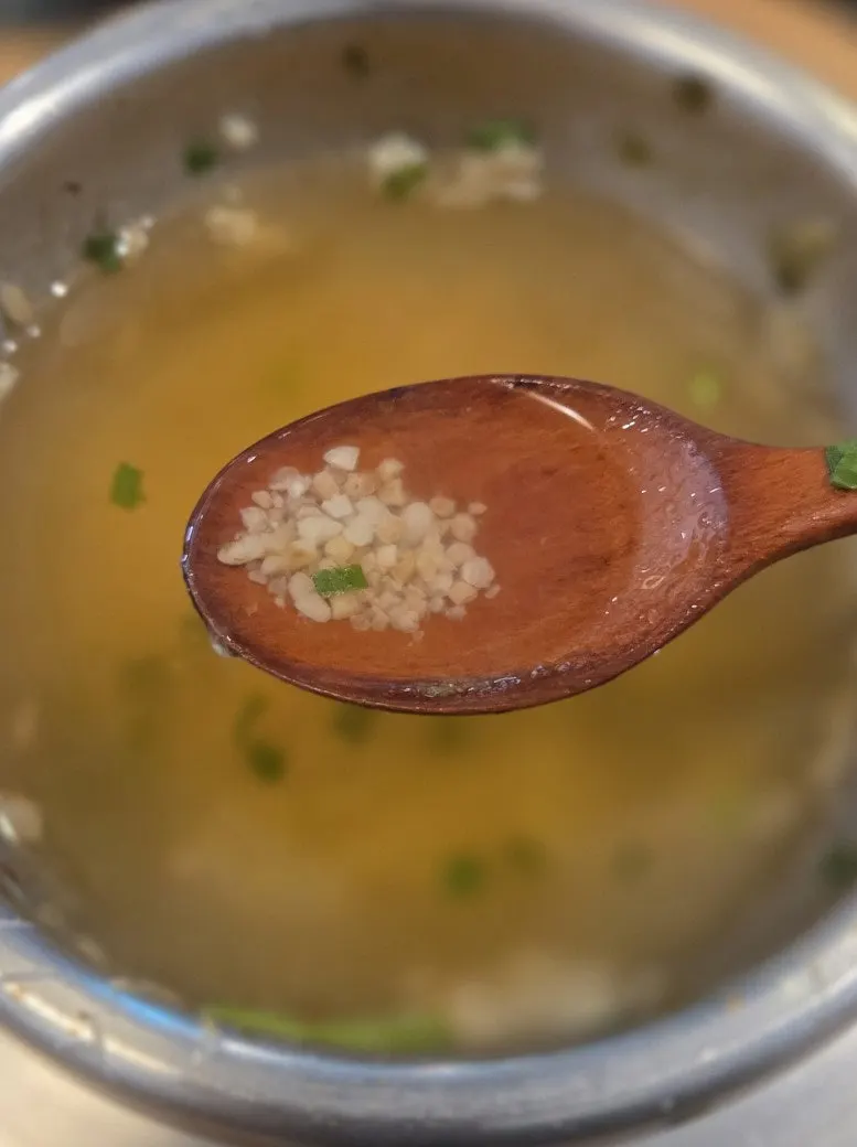 Broth poured over nurungji at the bottom of the pot to finish