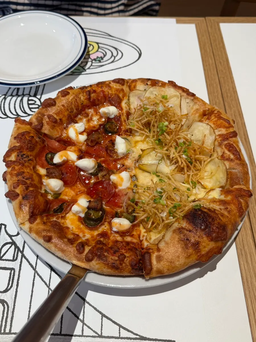 Half-and-half pizza and pasta set on the table