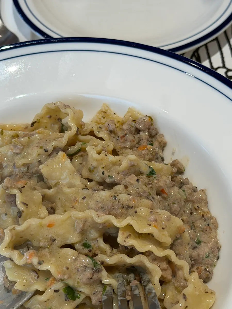 Ragu pasta topped with Reggiano cheese